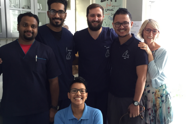 A group of veterinary colleagues smiling at the camera